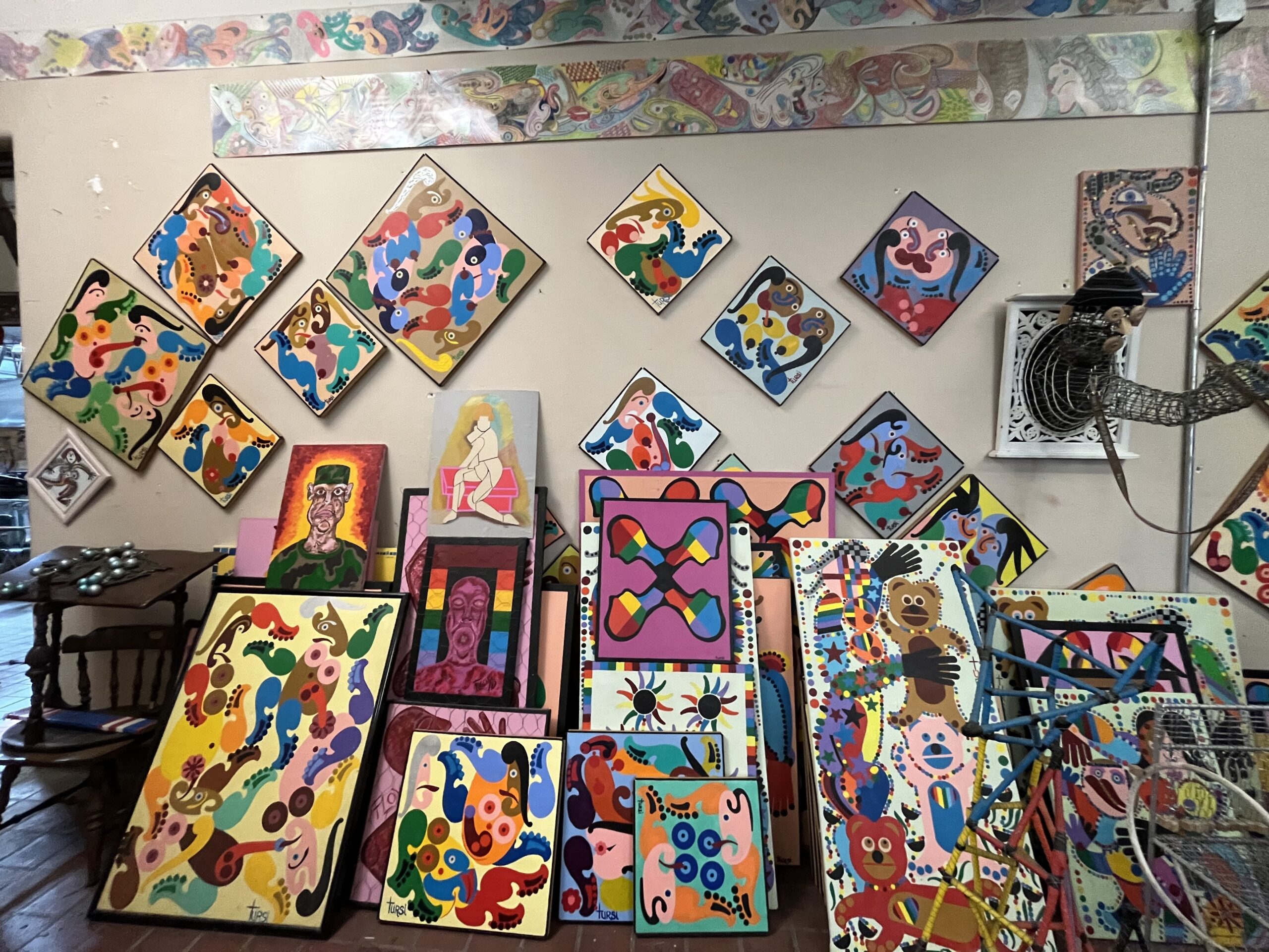 Colorful abstract artworks cover the floor and walls.