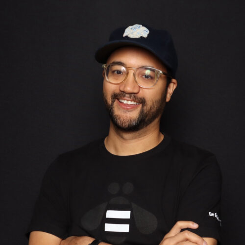 man with beard, arms crossed, smiling at camera