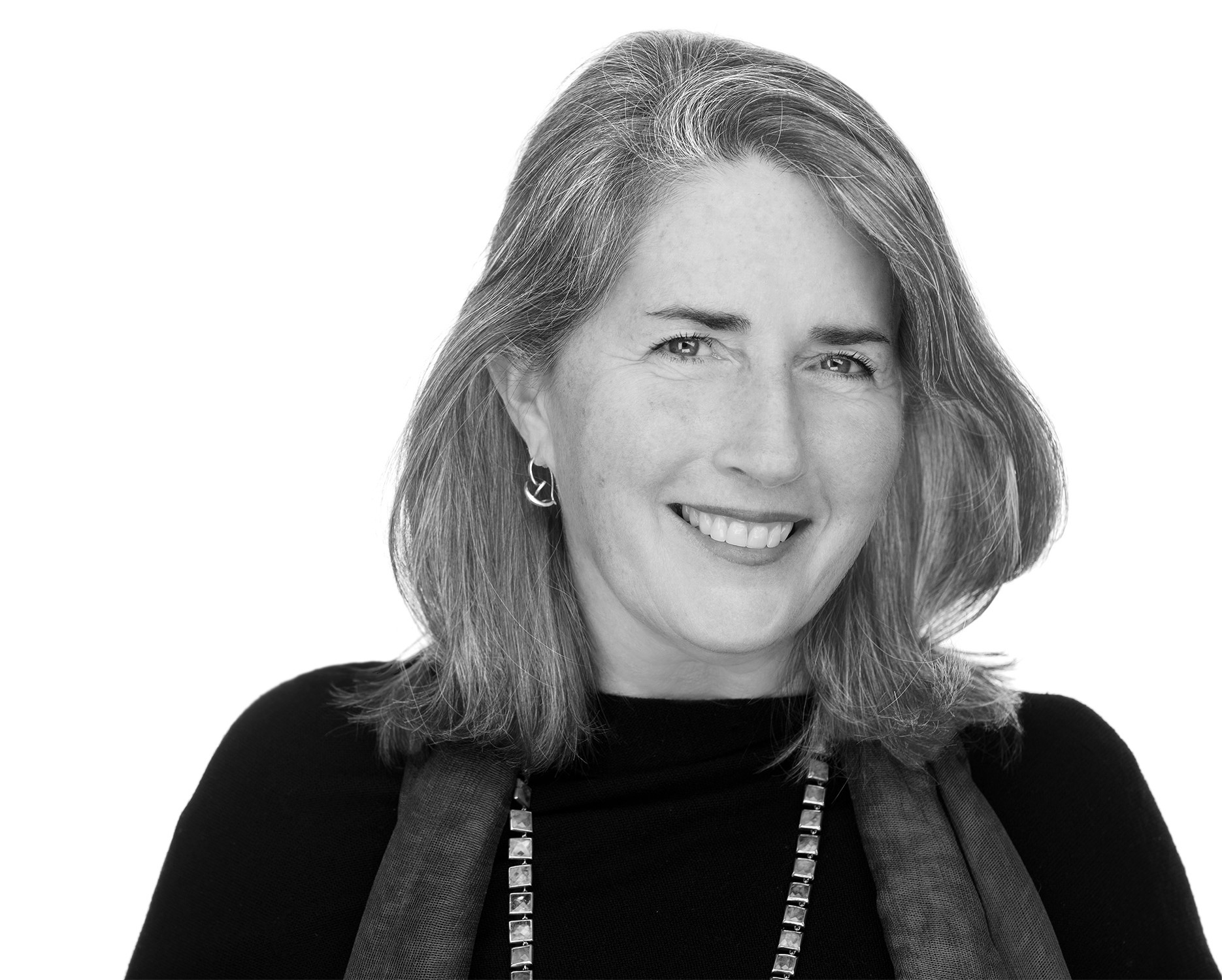 Black and white portrait of a smiling Susan T. Rodriguez