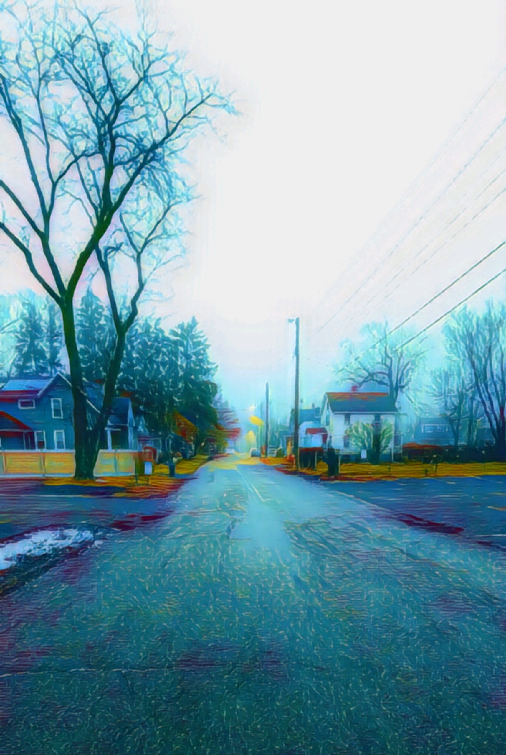 Digital painting or heavily processed photograph of a quiet suburban street. Houses and bare winter trees line the road, with electric lines visible overhead. The scene glows in vibrant blues, yellows, and reds, creating a surreal, painterly effect.