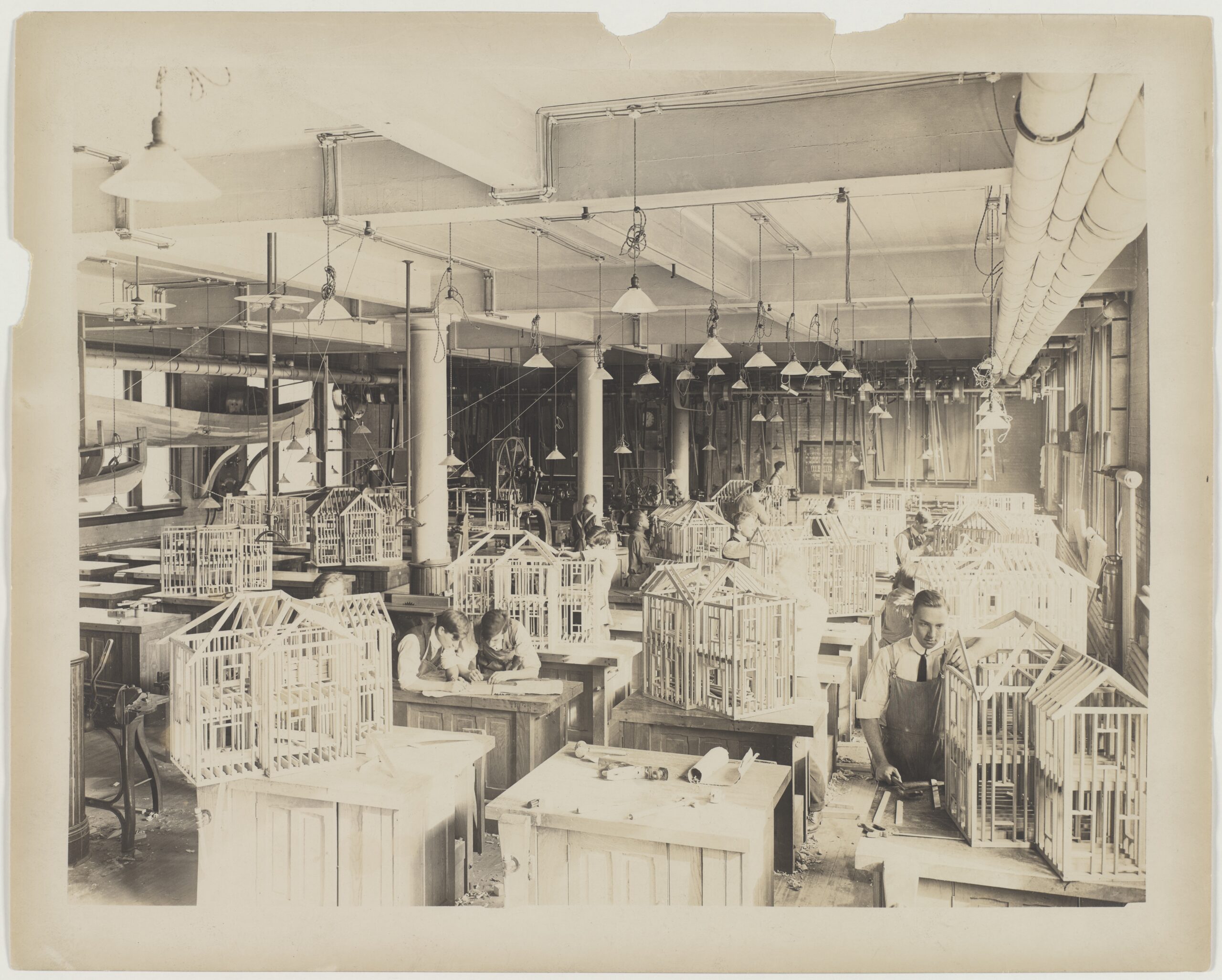 Architecture students construct wooden models in a studio around the turn of the 20th century.