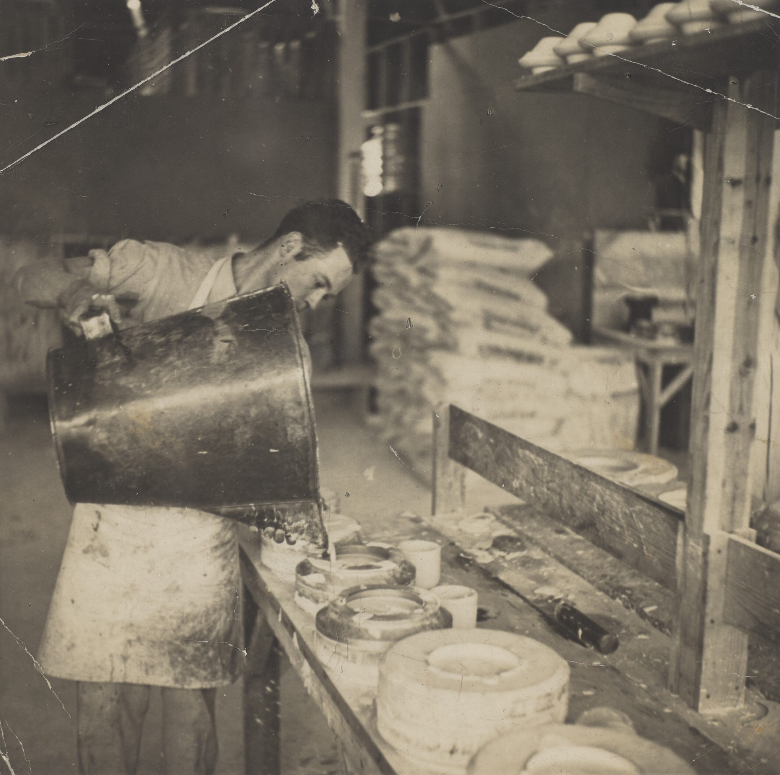 A student pours liquid into a mold for a class taught by Eva Zeisel.
