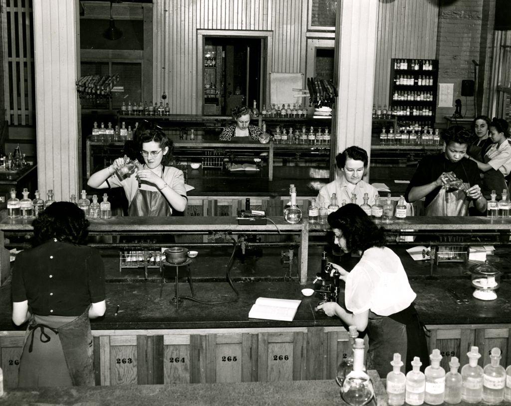Students conduct chemistry experiments around the mid-20th century.