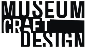 Black-and-white “MUSEUM CRAFT DESIGN” logo in bold, condensed uppercase letters stacked over three lines, with a thick horizontal black bar running across the middle of the design.