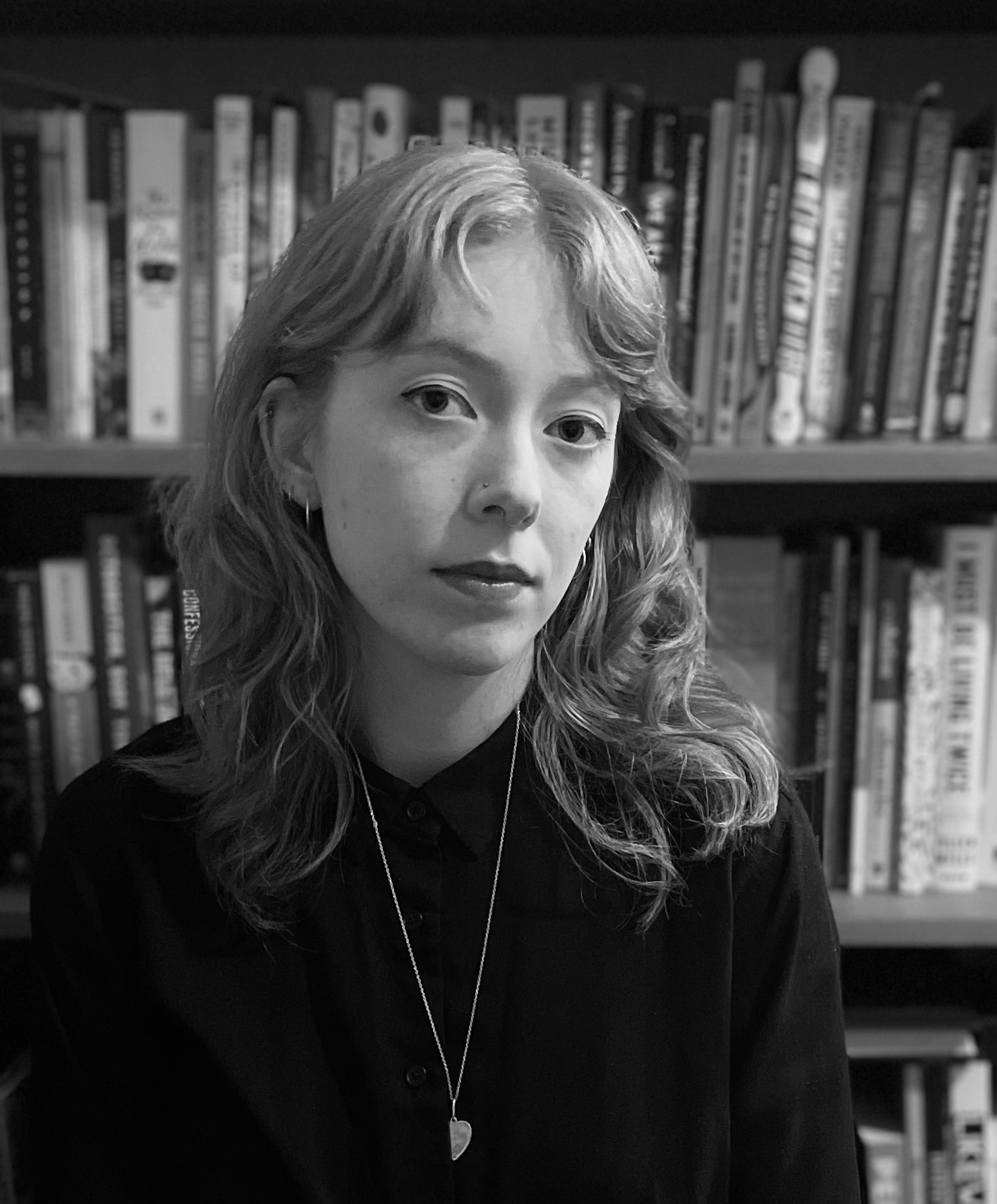 A black and white headshot shows alumna Hanna Pennington with bookshelves in the background.