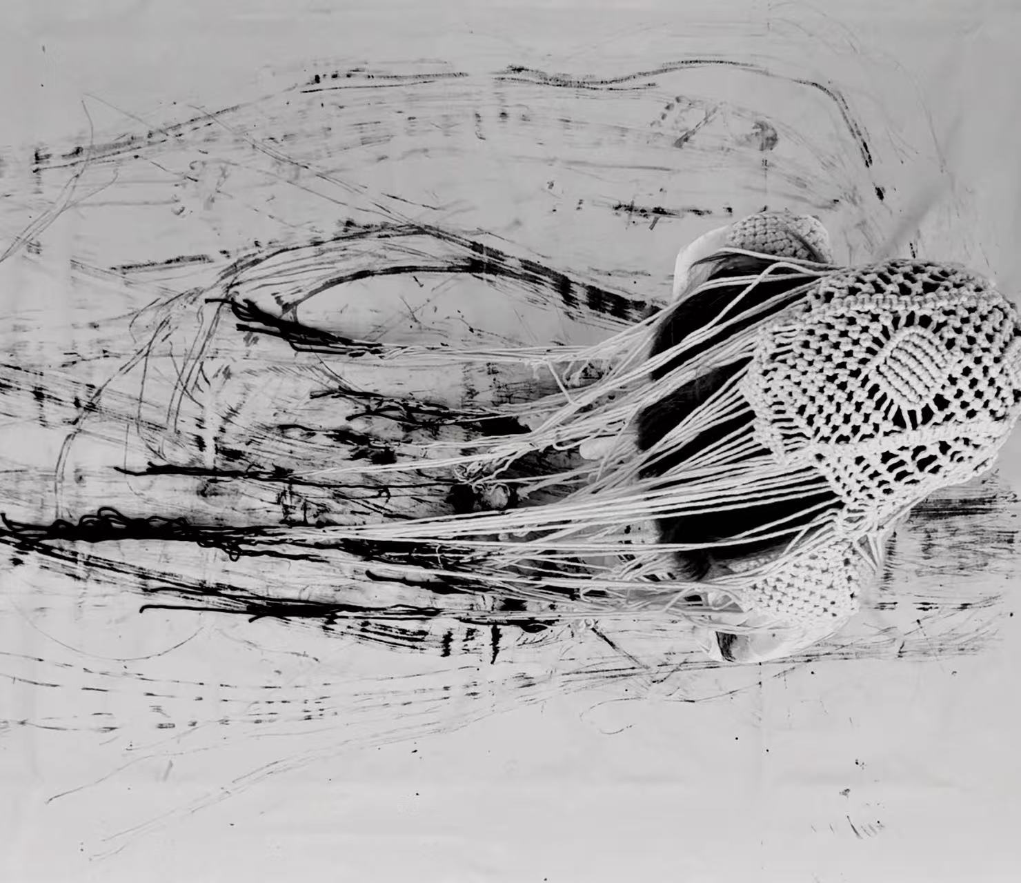 Abstract painting and macramé yarn applied to the body with black ink.
