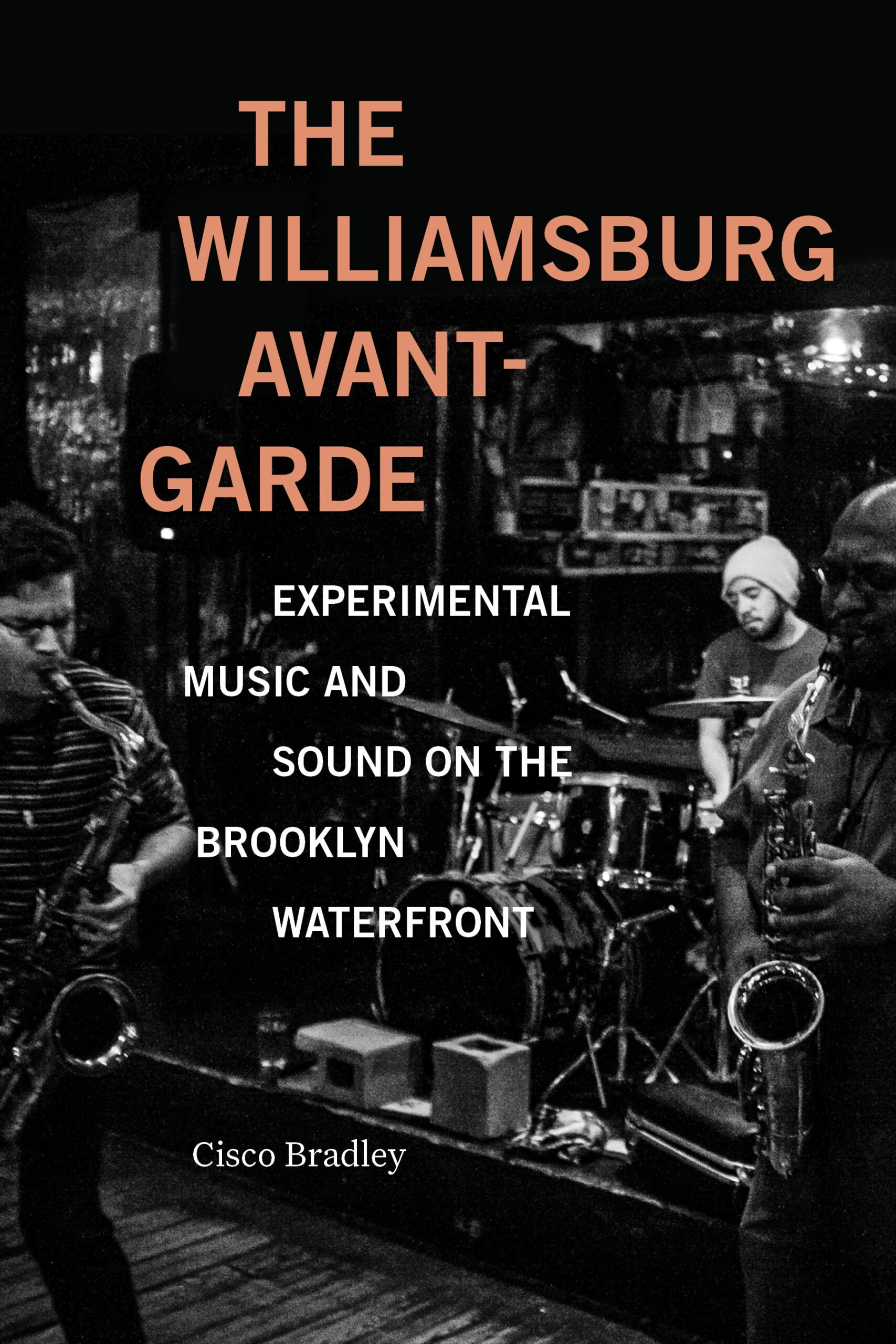 The cover features a dark, stylized background with the title "THE WILLIAMSBURG AVANT-GARDE" prominently displayed in orange. Below, the subtitle reads "EXPERIMENTAL MUSIC AND SOUND ON THE BROOKLYN WATERFRONT." The author's name, "Cisco Bradley," appears at the bottom. In the background, musicians can be seen performing, with one playing a saxophone and another on drums, creating a lively, artistic atmosphere.
