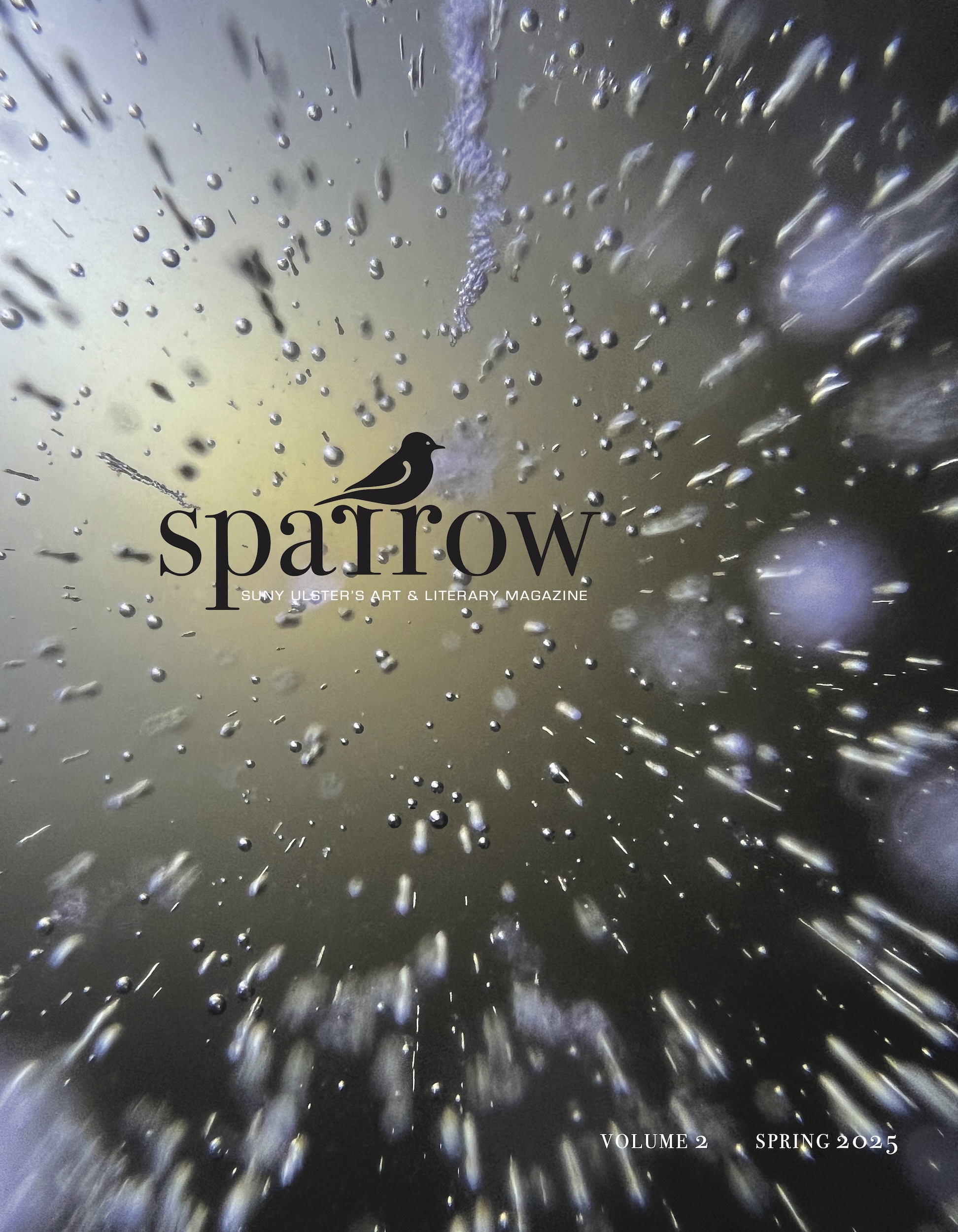 A magazine cover featuring the title "sparrow" in a bold font at the center, accompanied by an illustration of a bird. The background shows a blurred, abstract image with bubbles and light reflections, creating a watery effect. The text below the title indicates it is SUNY Ulster's Art & Literary Magazine, along with "VOLUME 2" and "SPRING 2025."