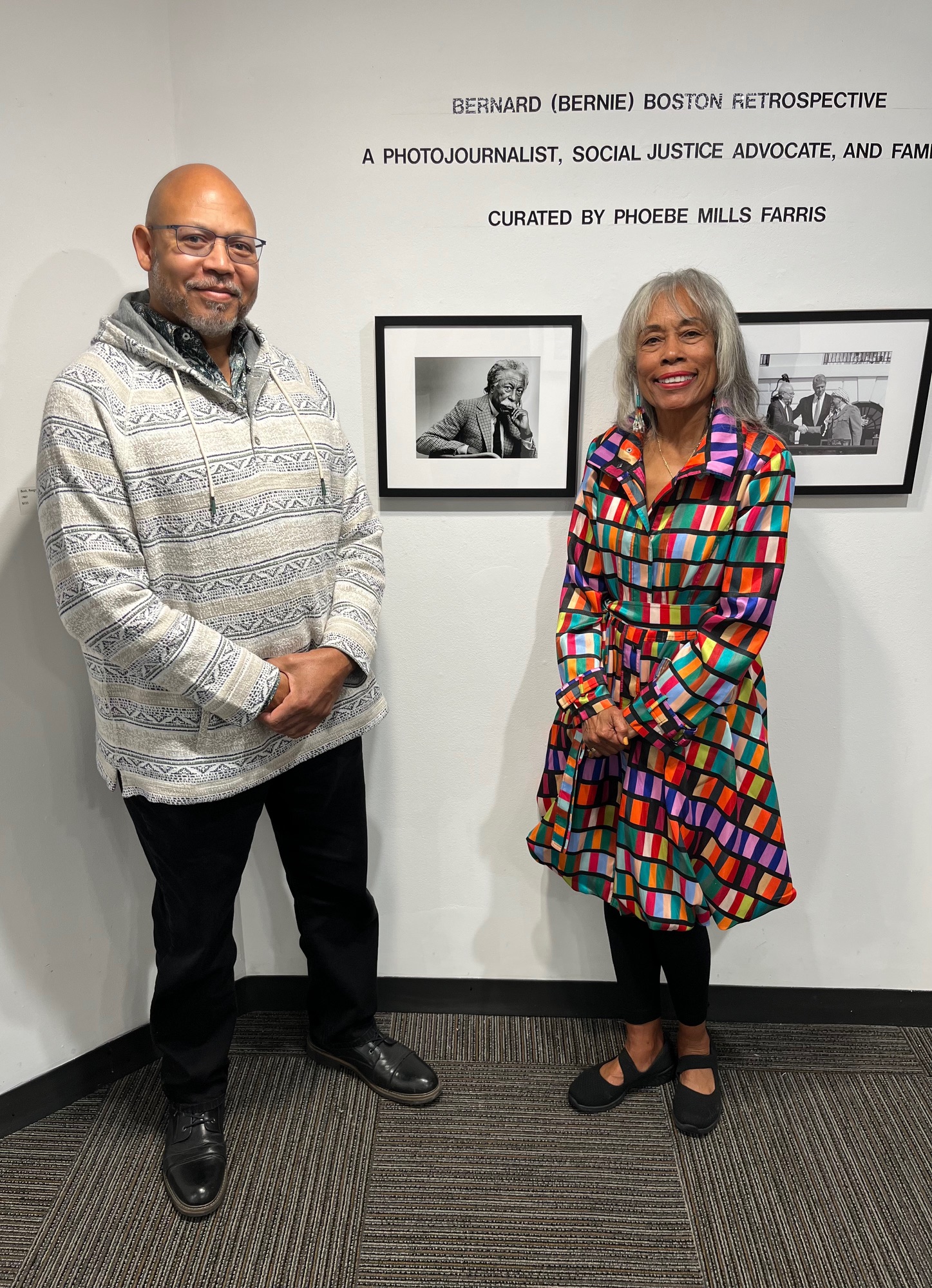 Dr. Phoebe Farris and John Whitley pose in front of a museum wall