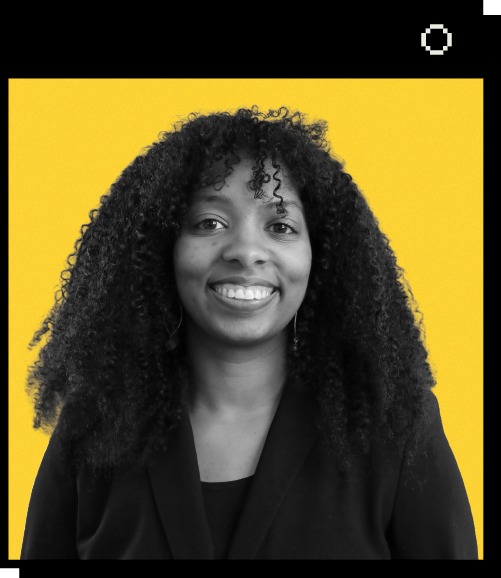 Headshot of Catherine Chattergoon against a yellow background. Catherine has curly hair and smiles at the camera. She is wearing a black blazer over a dark top.
