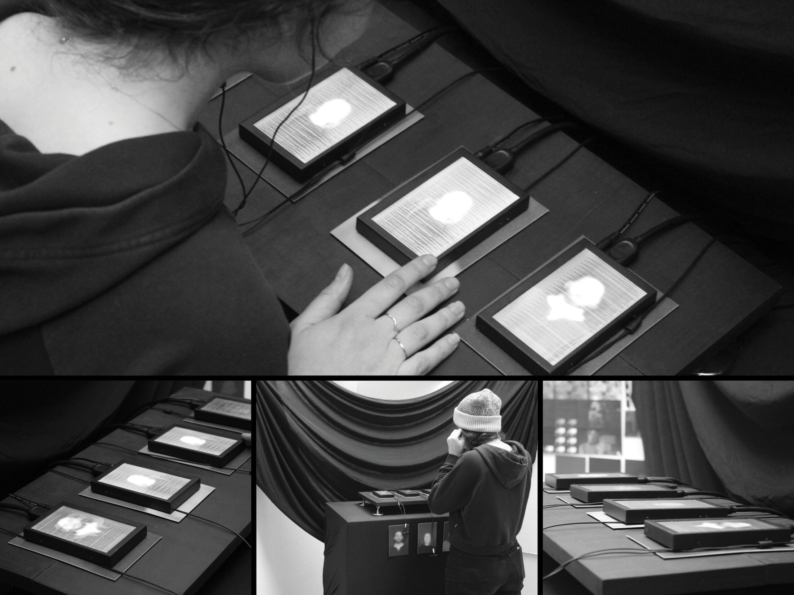 A person leans over a table with multiple small screens displaying indistinct faces, connected by wires. The scene is in black and white, with draped fabric in the background. Additional images show different angles of the installations, highlighting the displays and another individual standing and interacting with the setup.