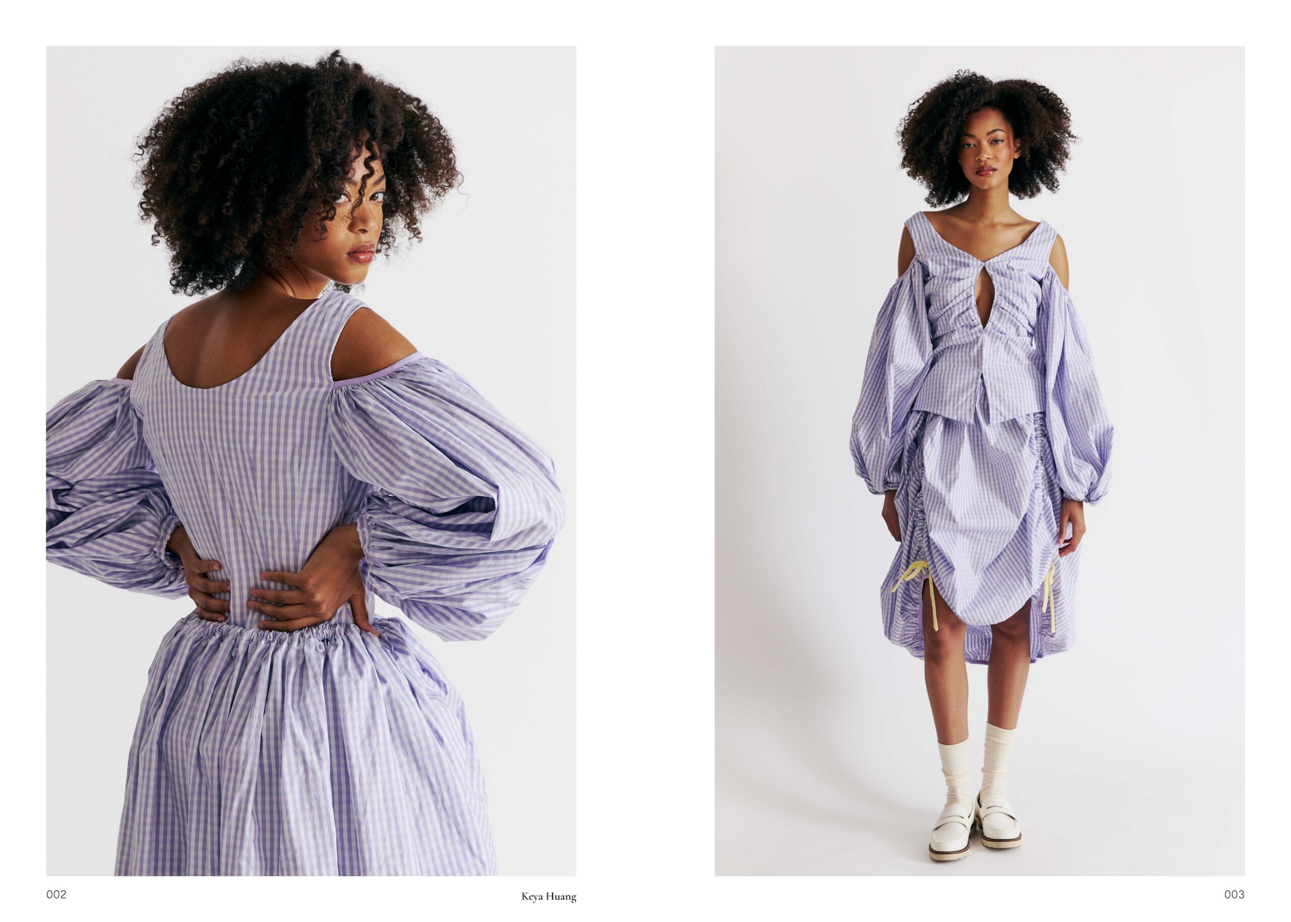 A model with curly hair is wearing a stylish dress with a purple and white striped pattern. The dress features puffed sleeves and cut-out shoulders, with gathering at the waist. The design has a keyhole detail at the front and a layered appearance, with ties on the skirt. The model is posed in two perspectives: one from the back and one from the front, standing on a white background.