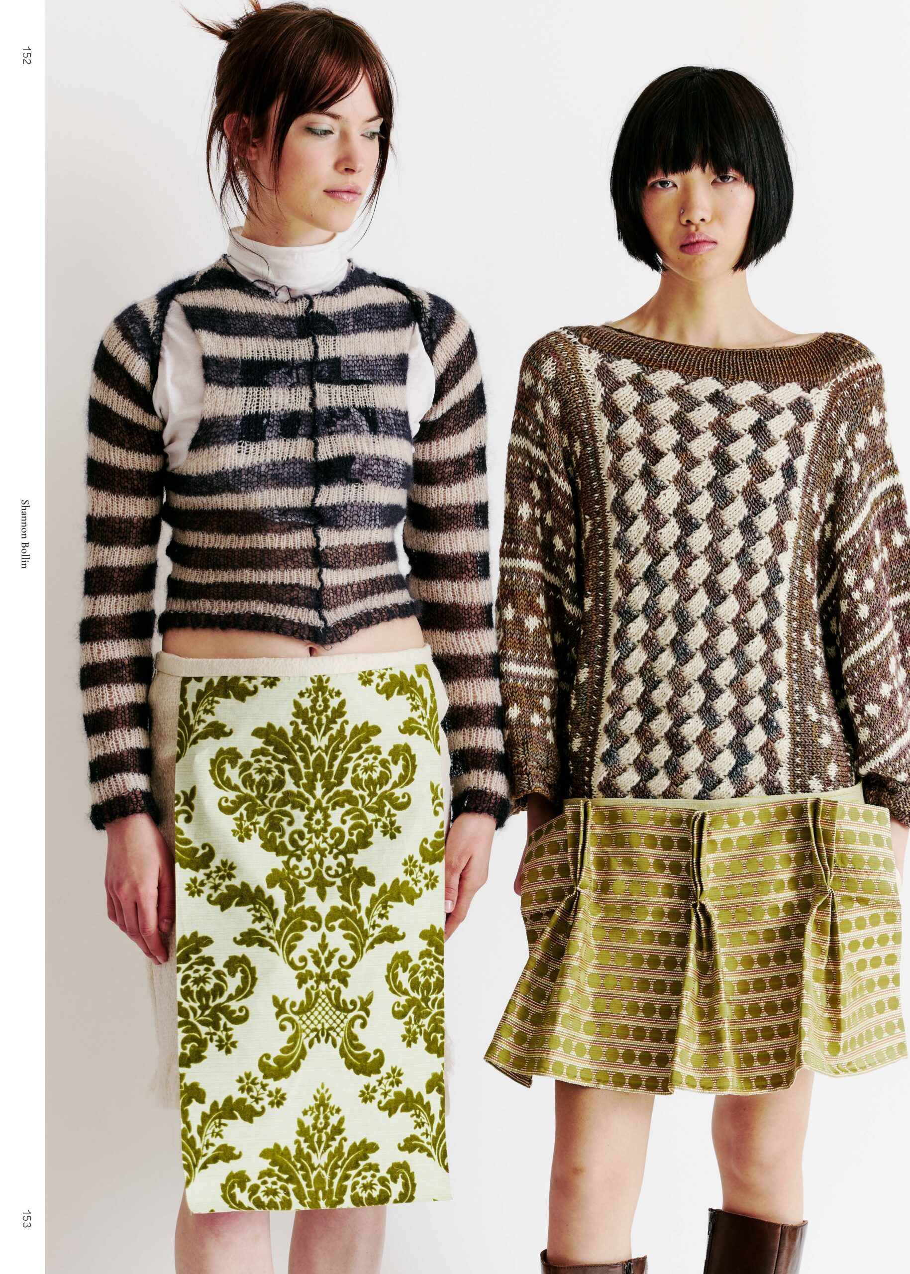 Two women stand side by side in fashion outfits. On the left, a woman wears a striped, cropped sweater with long sleeves, paired with a skirt featuring a green and white damask pattern. On the right, another woman sports a loose, textured sweater and a pleated, patterned skirt in shades of green. The background is plain white, highlighting their outfits.