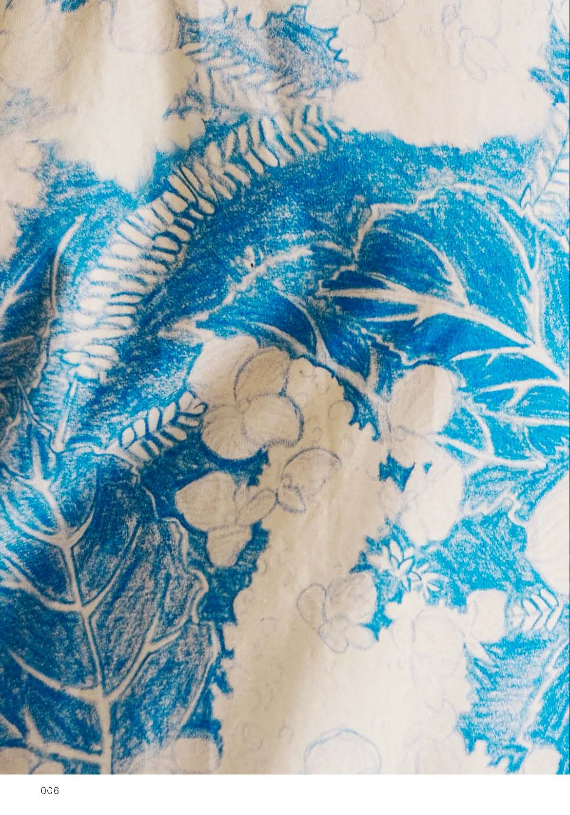 A close-up image of fabric featuring a floral and leaf pattern in vibrant blue against a light background. The design includes different shades of blue pencil or crayon strokes, highlighting various botanical shapes, with some lighter outlines suggesting flowers and leaves. The texture of the fabric appears slightly wrinkled, adding depth to the visual.