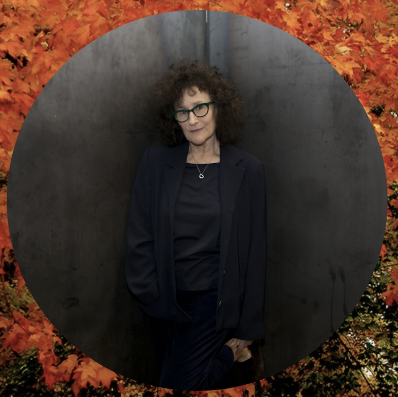 An image of Lynne Tillman with fall foliage in the background.