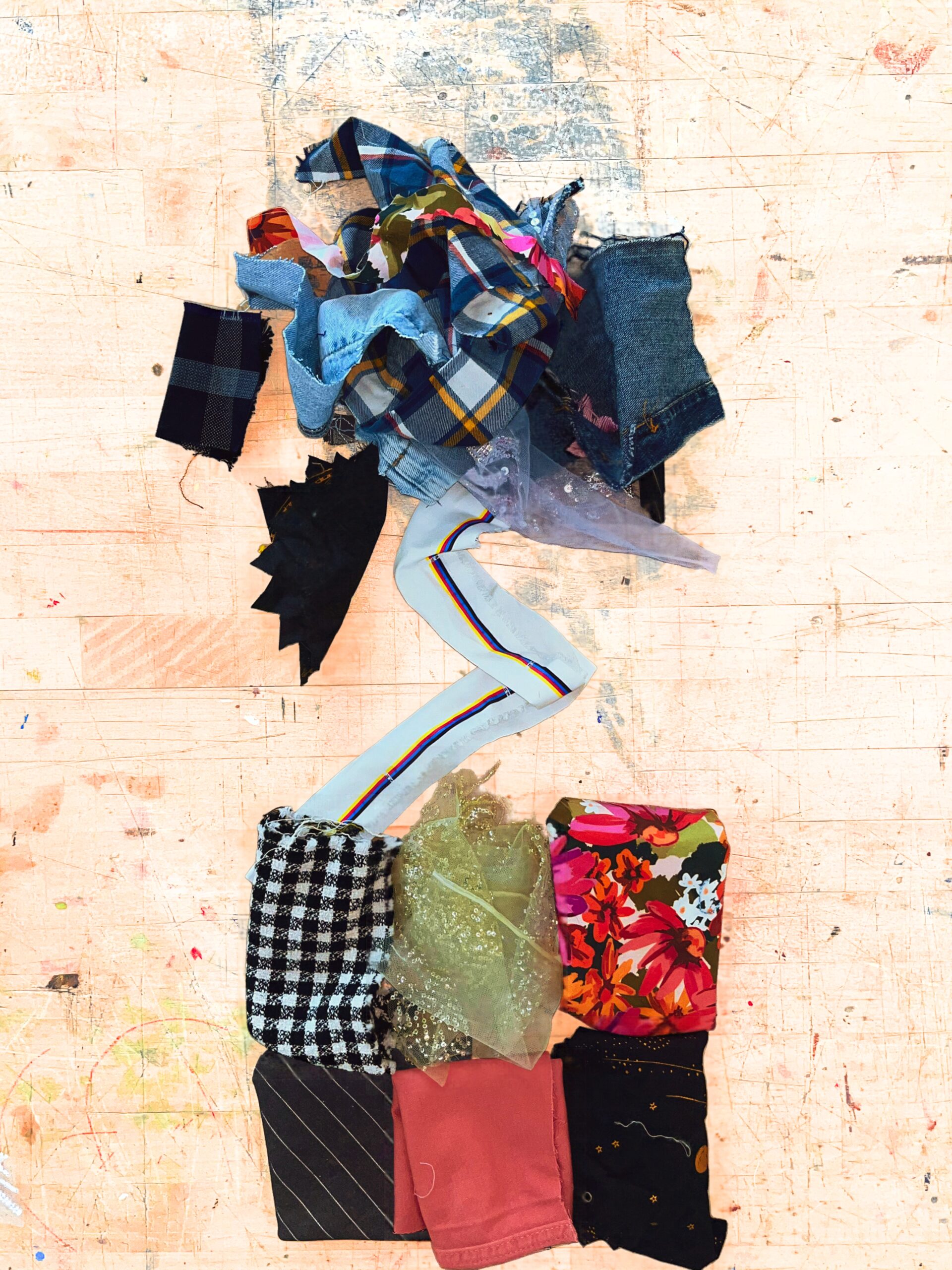 a pile of colorful fabric scraps on a wooden table