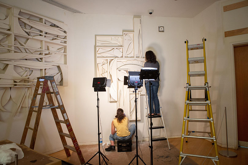 Sarah Nunberg (right) and Pratt student Lauryl Sandman treat overpainted wood surfaces with an innovative cleaning system developed in Florence, revealing Nevelson’s original paint for the first time in decades