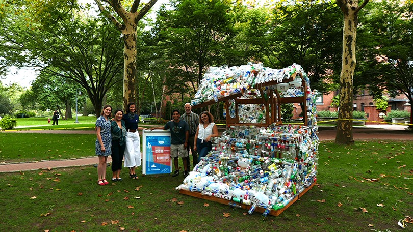 Blue week sculpture with students on campus