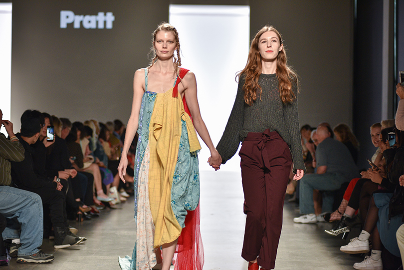 Mila Sullivan walks the runway with a model wearing one of her looks at Pratt Shows: Fashion | The Work in May 2017(photo: Fernando Colon)