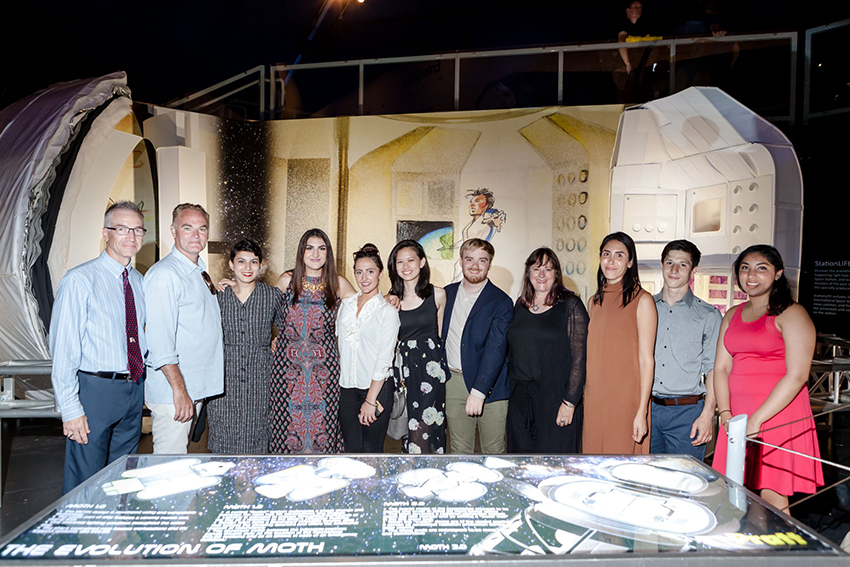 Image: (L-R) Tracy R. Gill, Deputy Chief Technologist at NASA Kennedy Space Center;  Michael Morris, Adjunct Assistant Professor of Architecture; students Amira Selim, Elvira Melamed, Larissa Naegele, Michelle Chung, Jason Solosk;, Rebeccah Pailes-Friedman, Adjunct Associate Professor of Industrial Design; Visiting Instructor Melodie Yashar; and students John Doria and Rhea Gopal at the Mars Transit Habitat exhibition opening reception at the Intrepid Sea, Air & Space Museum