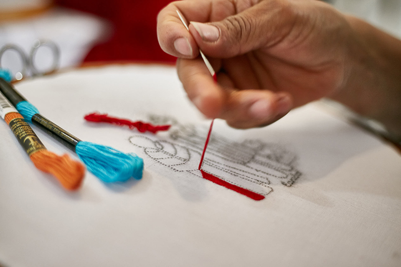 Hand working on embroidery