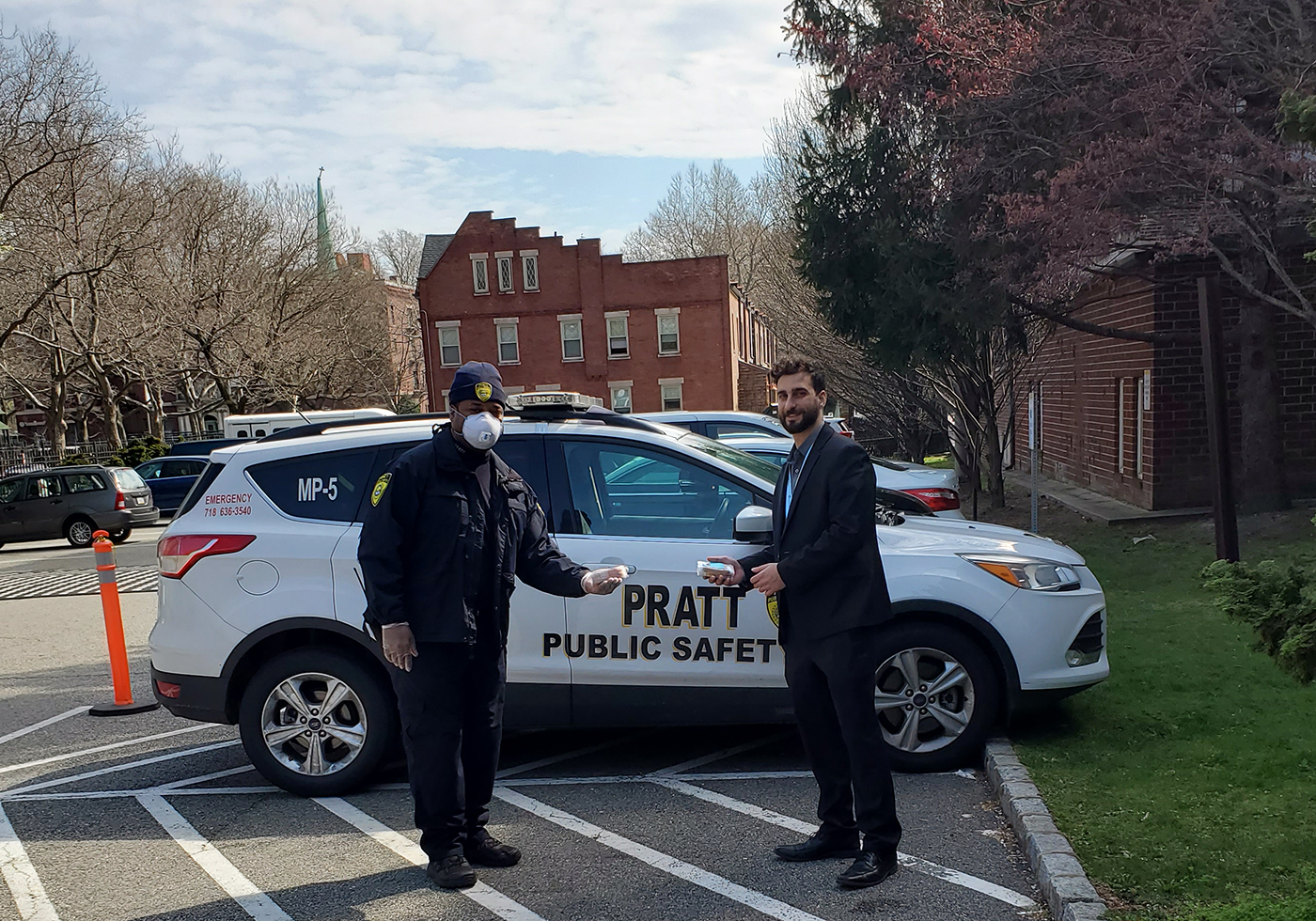 Pratt Public Safety Tour Supervisor Jermaine Elgin handing off donated MetroCards to Mohamed Hamed, Physician Relations and Business Development at the Brooklyn Hospital Center